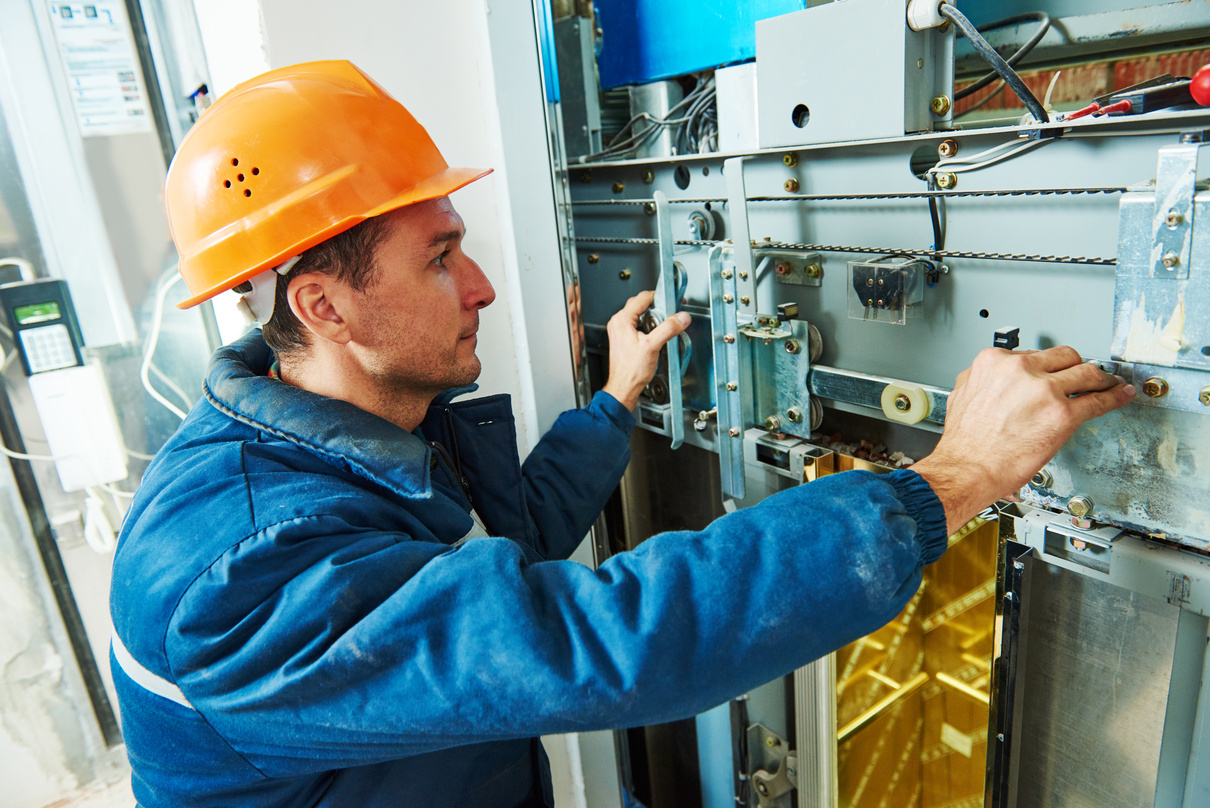 Technician Worker Adjusting Elevator Mechanism